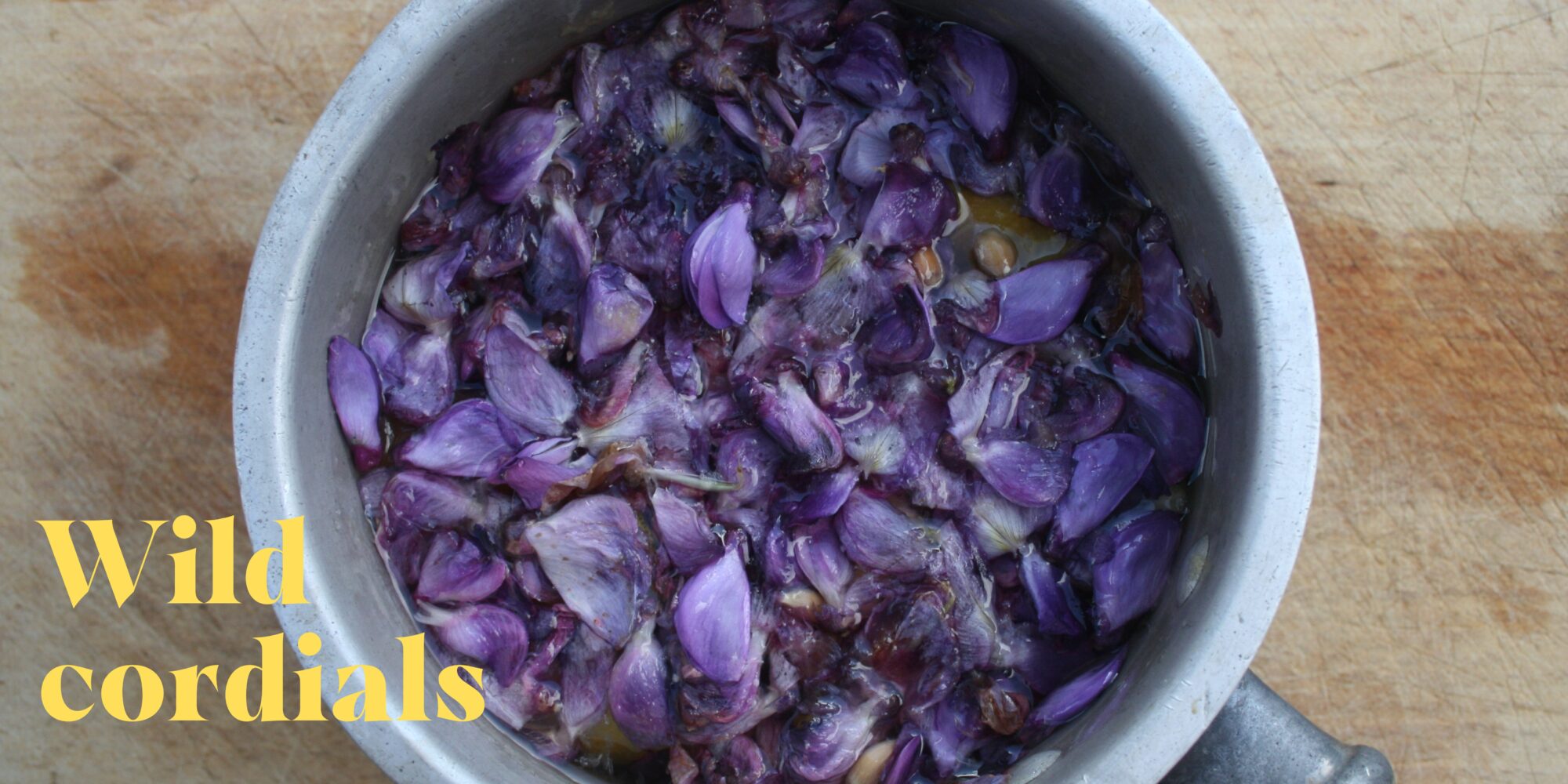 A bowl of purple petals steeping in liquid
